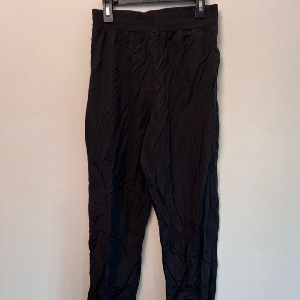 classic black nylon joggers with an elastic waistband and cuffs.